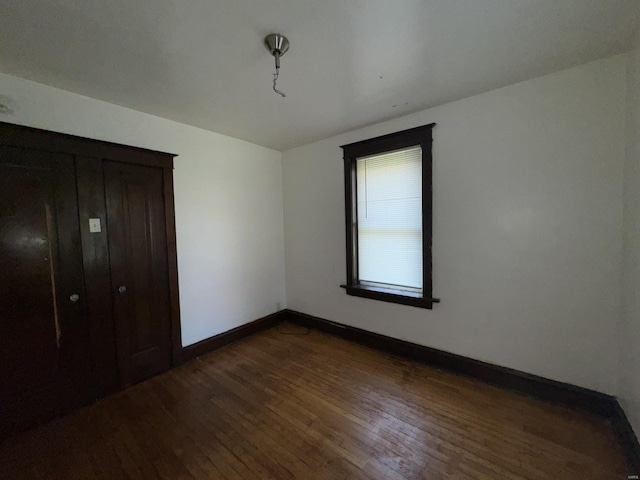 5741 Floy Ave, Saint Louis, MO 63136 - unfurnished bedroom with dark wood finished floors and baseboards