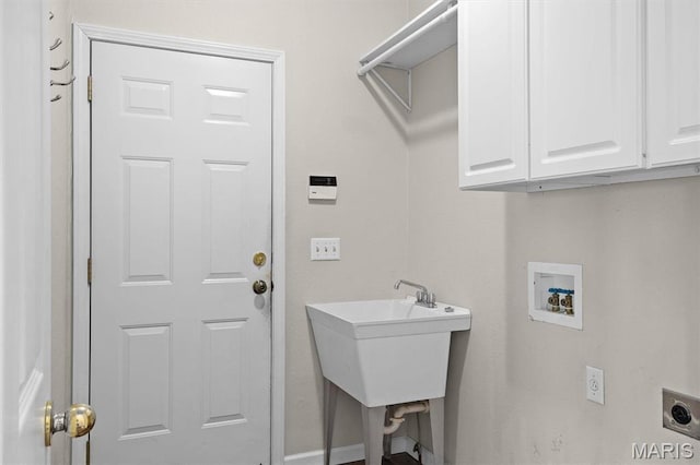 laundry area featuring electric dryer hookup, cabinet space, hookup for a washing machine, and baseboards