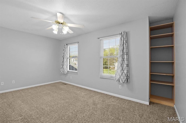 unfurnished bedroom with carpet, baseboards, and a ceiling fan