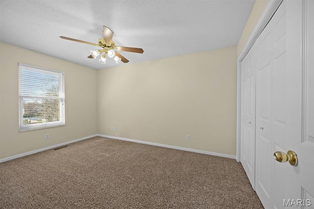 unfurnished bedroom featuring carpet, a closet, and baseboards