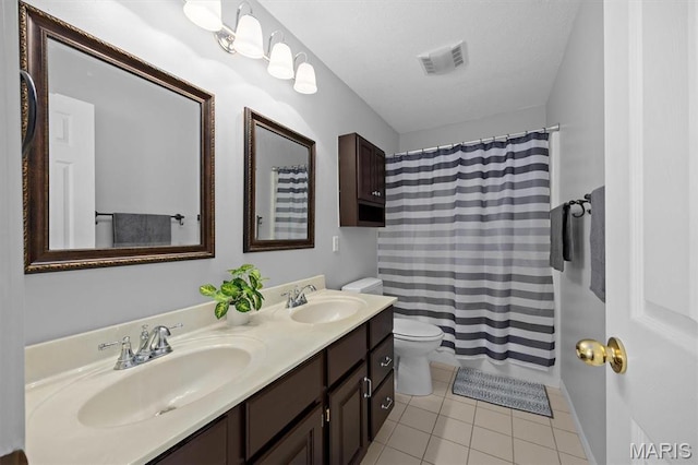 bathroom featuring tile patterned flooring, toilet, double vanity, and a shower with shower curtain