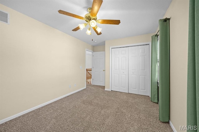 unfurnished bedroom with carpet floors, baseboards, a ceiling fan, and a closet