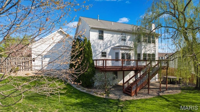 back of house with a deck, a chimney, stairway, and a yard