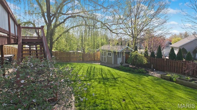 view of yard with an outbuilding, stairway, a shed, and a garden