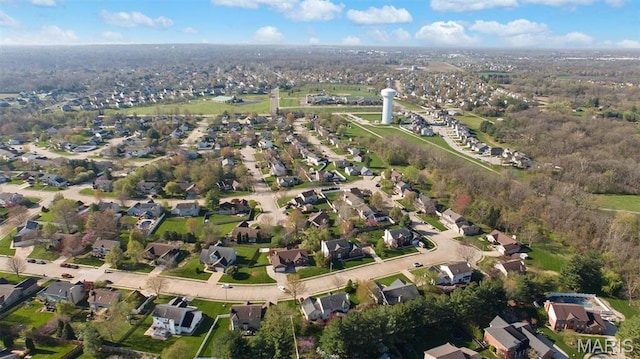 aerial view of property and surrounding area with nearby suburban area