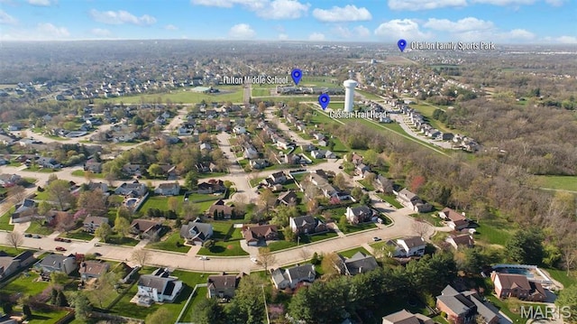 aerial view of property and surrounding area featuring nearby suburban area