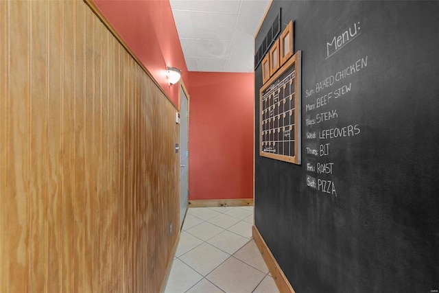 corridor with tile patterned floors, baseboards, and mail area