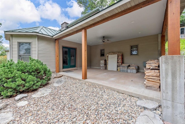 back of property featuring a standing seam roof, french doors, metal roof, ceiling fan, and a patio