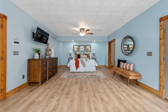 bedroom with light wood-type flooring, baseboards, an ornate ceiling, and ceiling fan