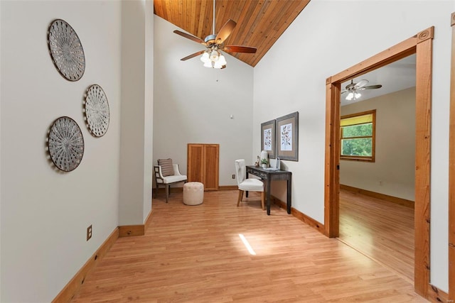 living room with wooden ceiling, a ceiling fan, light wood-style flooring, high vaulted ceiling, and baseboards