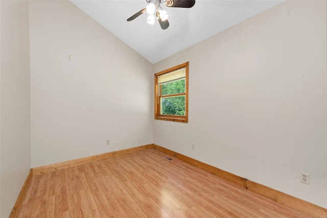 unfurnished room with light wood finished floors, vaulted ceiling, ceiling fan, and baseboards