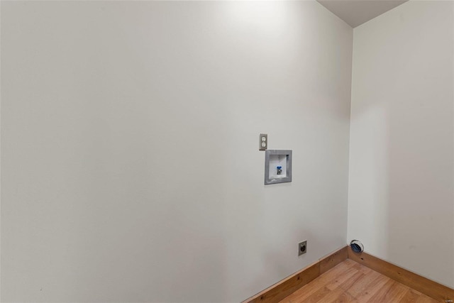 laundry area featuring electric dryer hookup, light wood-type flooring, washer hookup, and baseboards