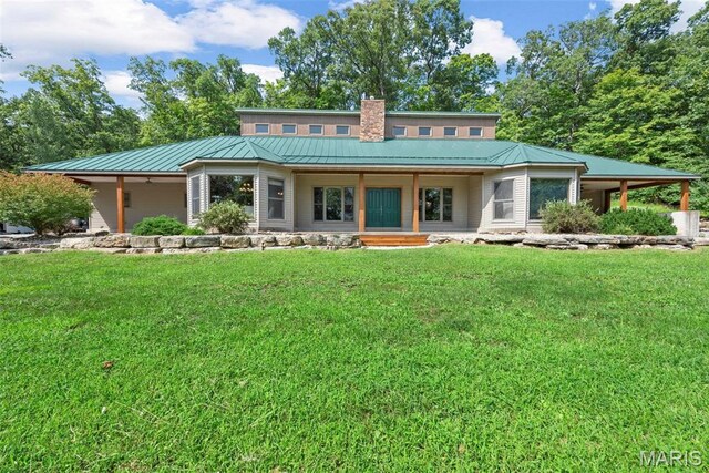 17102 Deer Mountain Rd, Marthasville, MO 63357 - back of property featuring a lawn, a standing seam roof, a chimney, and covered porch