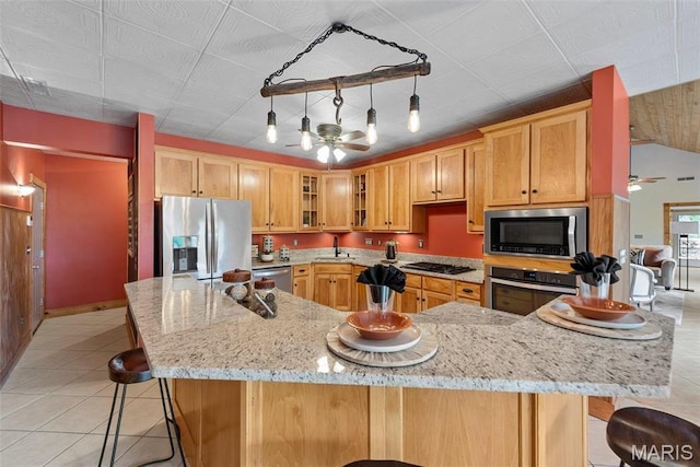 17102 Deer Mountain Rd, Marthasville, MO 63357 - kitchen with stainless steel appliances, a ceiling fan, light tile patterned flooring, a kitchen breakfast bar, and vaulted ceiling