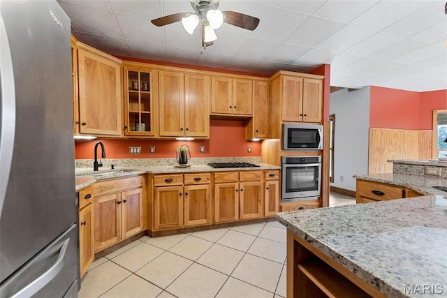 17102 Deer Mountain Rd, Marthasville, MO 63357 - kitchen with stainless steel appliances, a sink, a ceiling fan, glass insert cabinets, and light stone countertops