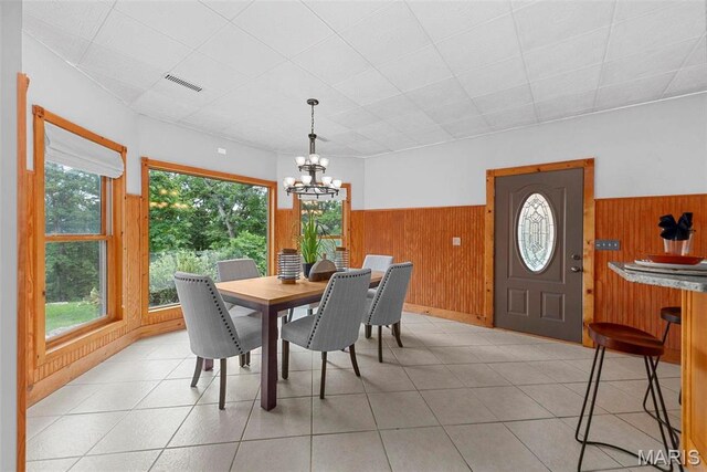 17102 Deer Mountain Rd, Marthasville, MO 63357 - dining room with wooden walls, wainscoting, a chandelier, light tile patterned floors, and a drop ceiling
