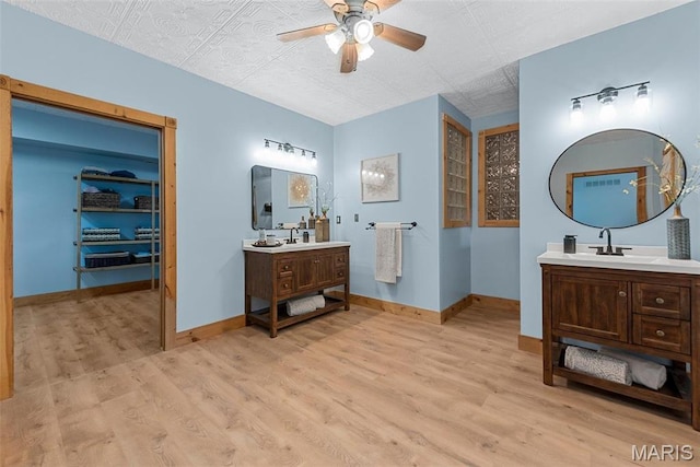 17102 Deer Mountain Rd, Marthasville, MO 63357 - bathroom featuring ceiling fan, wood finished floors, two vanities, and baseboards