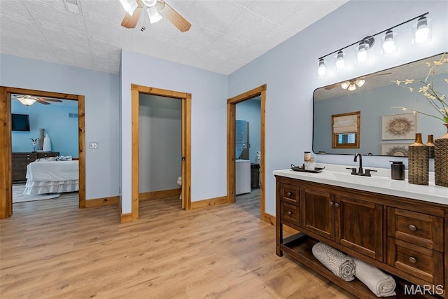 17102 Deer Mountain Rd, Marthasville, MO 63357 - ensuite bathroom featuring a ceiling fan, wood finished floors, toilet, vanity, and baseboards