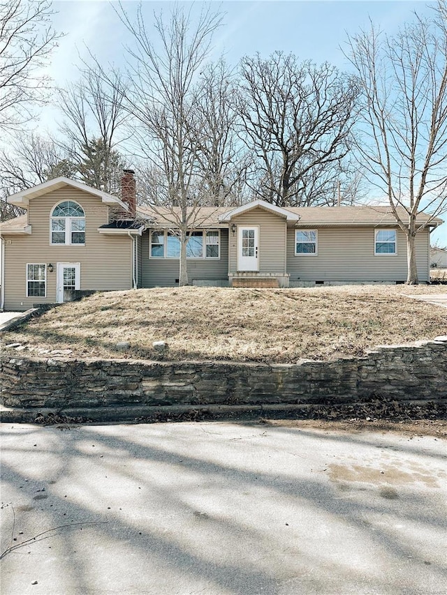 single story home with a chimney