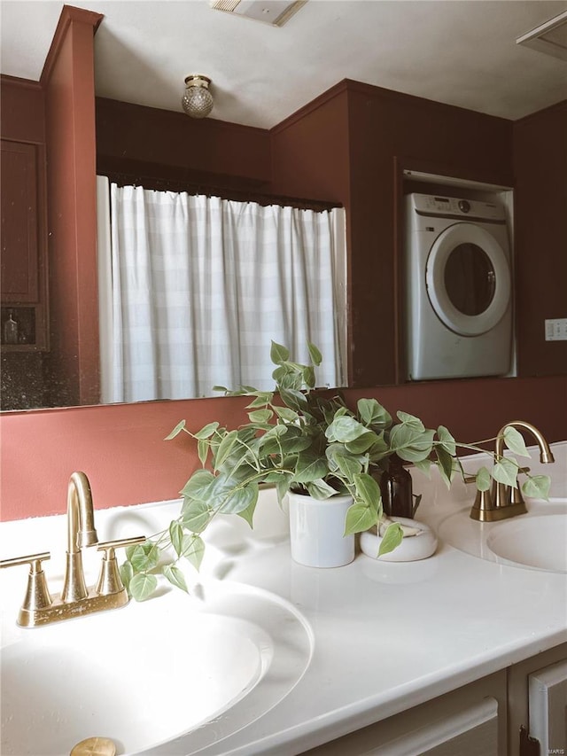 full bathroom featuring washer / dryer and vanity
