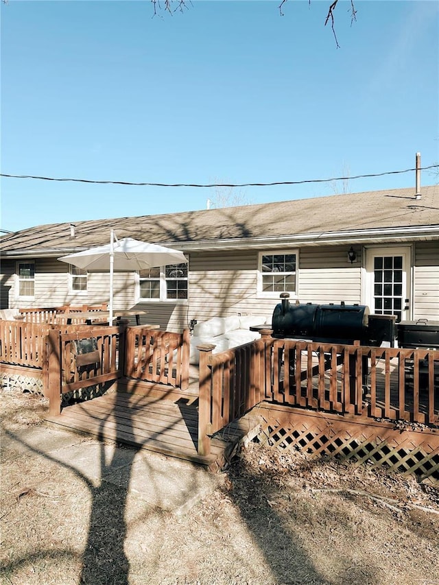 rear view of house with a wooden deck