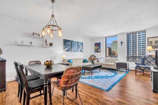 200 S Brentwood Unit 12F, Saint Louis, MO 63105 - dining area with wood finished floors and a chandelier