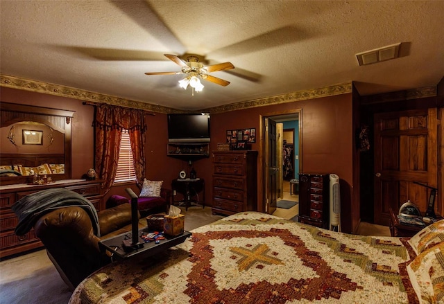 bedroom with a textured ceiling, ceiling fan, and carpet floors