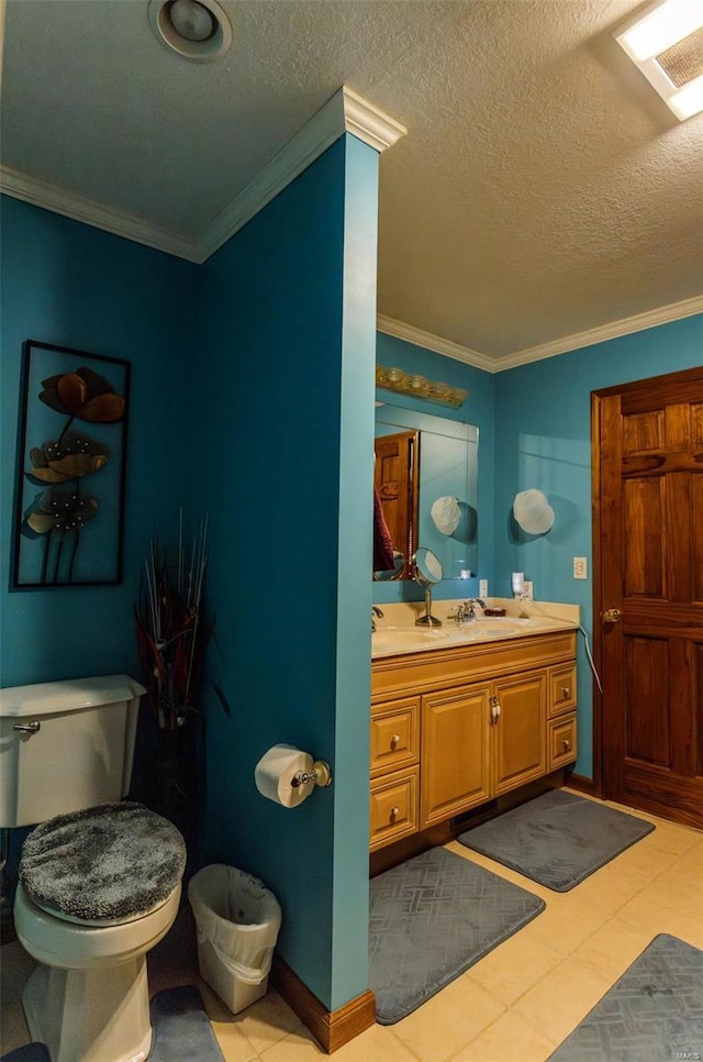 half bathroom with vanity, ornamental molding, toilet, a textured ceiling, and tile patterned flooring