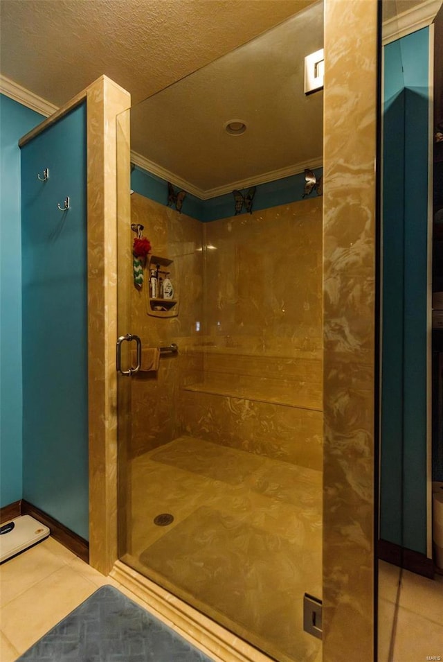 bathroom with ornamental molding, a stall shower, and tile patterned flooring