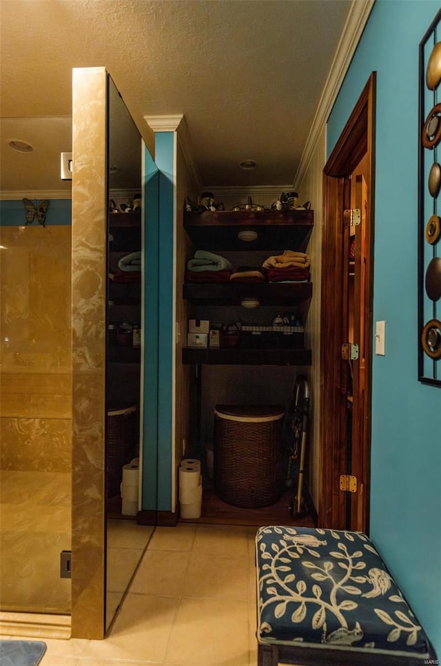 hallway featuring ornamental molding and tile patterned floors