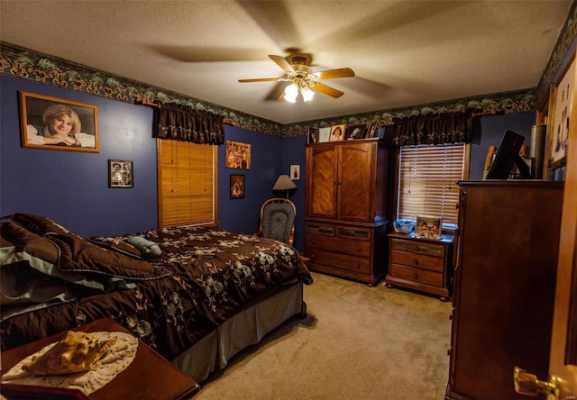bedroom featuring light carpet, a textured ceiling, and a ceiling fan