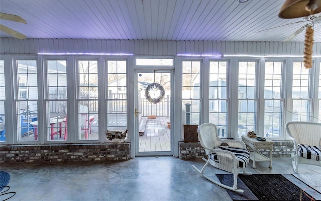 sunroom featuring concrete floors and healthy amount of natural light
