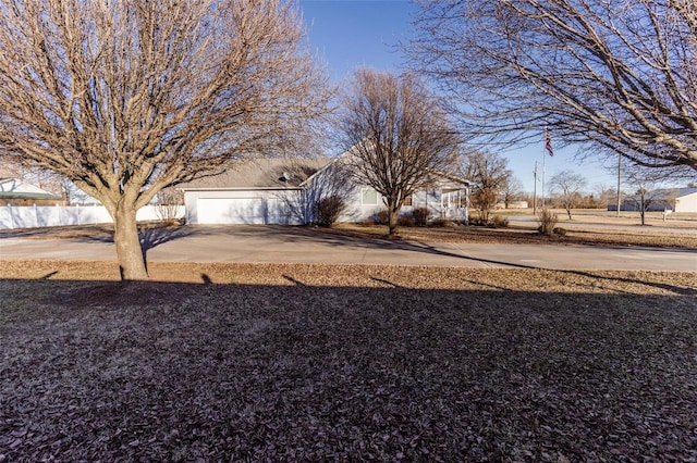 view of yard featuring driveway and fence