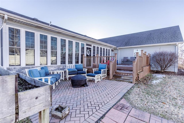 view of patio with an outdoor living space with a fire pit and a deck