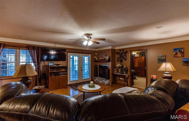 702 S 525th Rd, East Prairie, MO 63845 - living area with a ceiling fan, wood finished floors, plenty of natural light, ornamental molding, and a fireplace