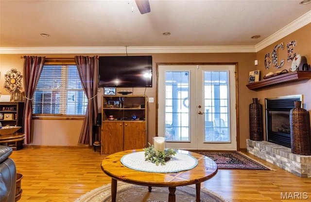 702 S 525th Rd, East Prairie, MO 63845 - living room with light wood finished floors, french doors, ornamental molding, a brick fireplace, and ceiling fan