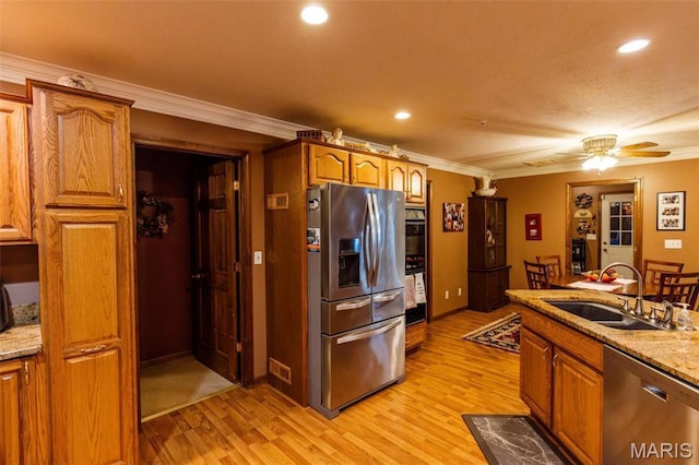 702 S 525th Rd, East Prairie, MO 63845 - kitchen featuring appliances with stainless steel finishes, a sink, light wood-type flooring, crown molding, and brown cabinetry