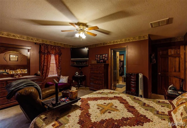 702 S 525th Rd, East Prairie, MO 63845 - carpeted bedroom with a textured ceiling and ceiling fan