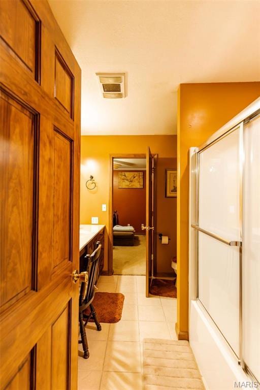 702 S 525th Rd, East Prairie, MO 63845 - bathroom featuring tile patterned flooring, vanity, toilet, and shower / bath combination with glass door