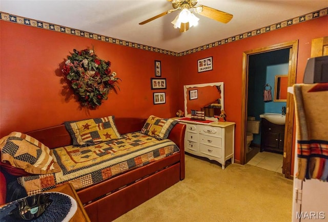 702 S 525th Rd, East Prairie, MO 63845 - bedroom with light carpet, ensuite bath, a sink, and ceiling fan