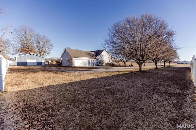 702 S 525th Rd, East Prairie, MO 63845 - view of property exterior with a detached garage and an outdoor structure