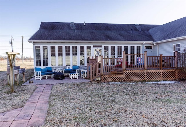 702 S 525th Rd, East Prairie, MO 63845 - back of property with a sunroom, a wooden deck, an outdoor living space, a shingled roof, and a patio