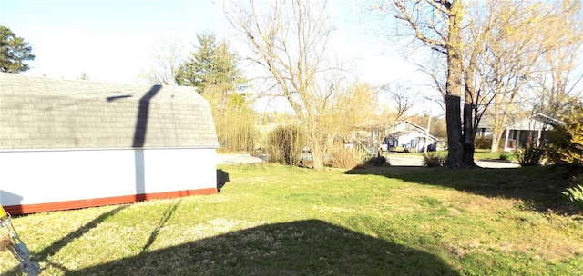 1306 Broadway St, Rolla, MO 65401 - view of green lawn with an outdoor structure and a shed