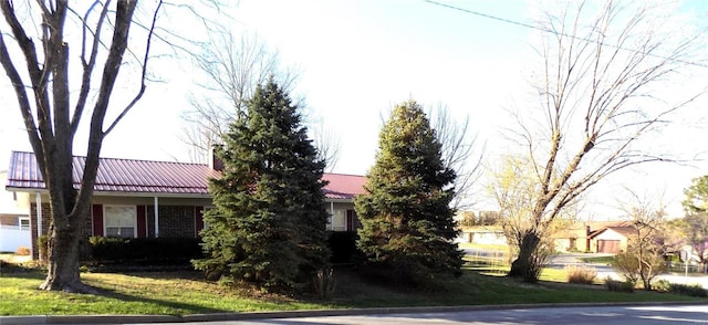 1306 Broadway St, Rolla, MO 65401 - view of front of home with a chimney and metal roof