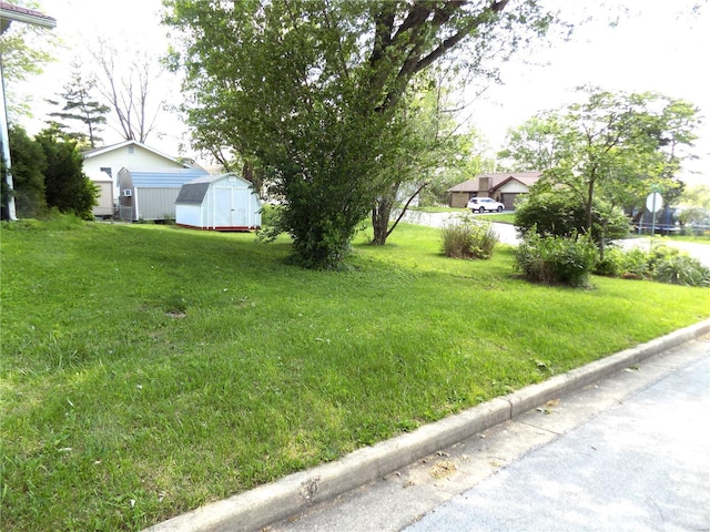 1306 Broadway St, Rolla, MO 65401 - view of grassy yard featuring a shed and an outdoor structure