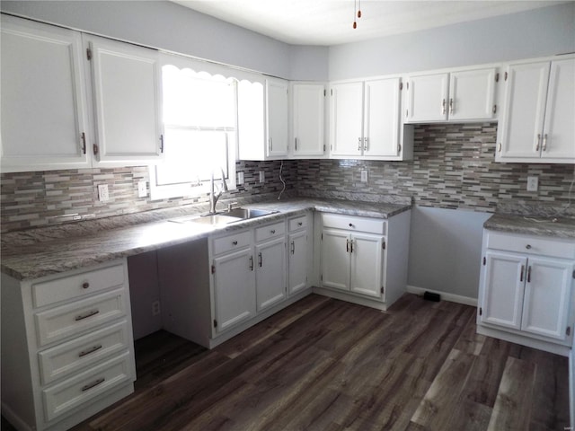 1306 Broadway St, Rolla, MO 65401 - kitchen with a sink, white cabinets, and decorative backsplash