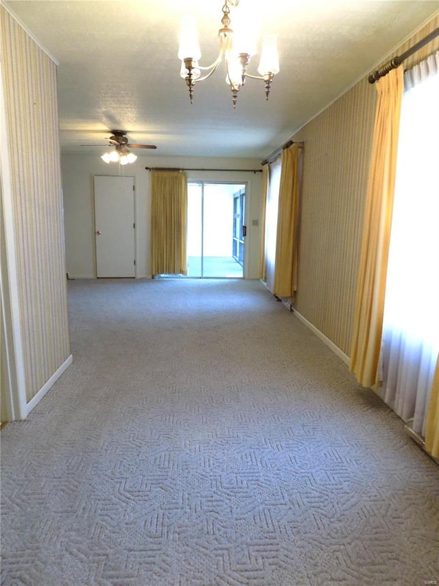 1306 Broadway St, Rolla, MO 65401 - empty room featuring light colored carpet, a chandelier, baseboards, and ceiling fan