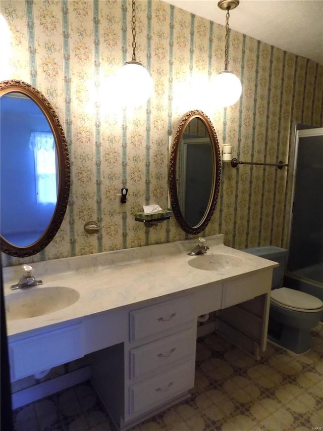 1306 Broadway St, Rolla, MO 65401 - bathroom featuring toilet, wallpapered walls, and double vanity