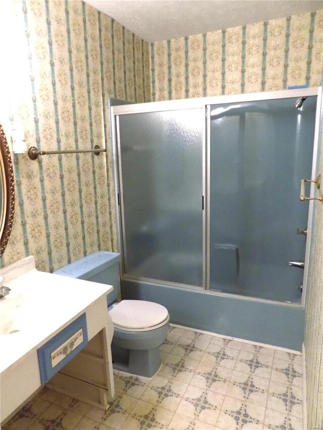1306 Broadway St, Rolla, MO 65401 - bathroom with tile patterned floors, toilet, vanity, bath / shower combo with glass door, and wallpapered walls