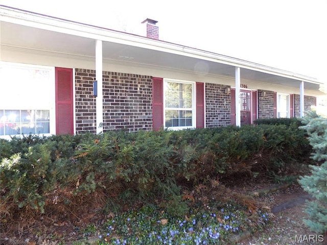 1306 Broadway St, Rolla, MO 65401 - view of exterior entry with brick siding and a chimney